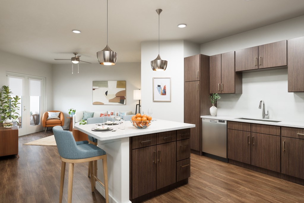 A modern kitchen with a dining area and a plant.