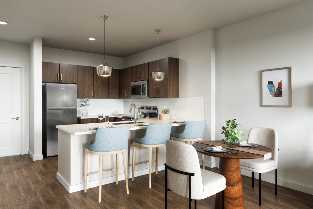 A modern kitchen with a dining table and chairs.