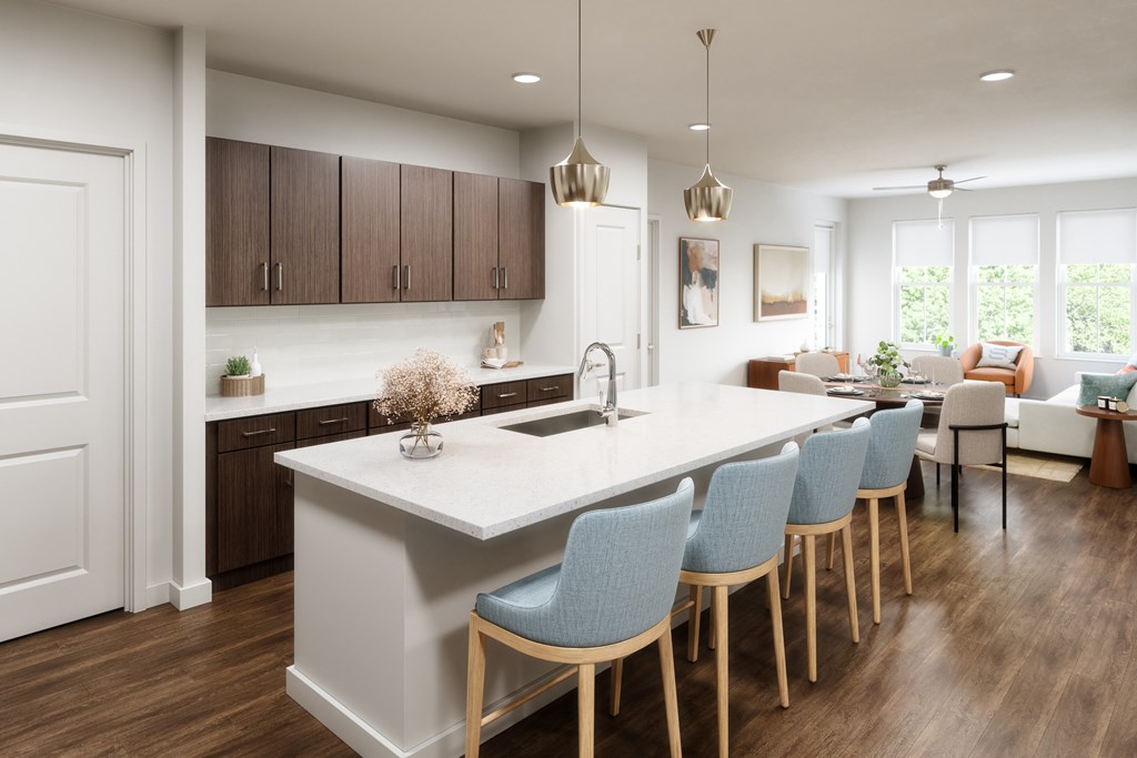A kitchen with a white island and blue chairs.