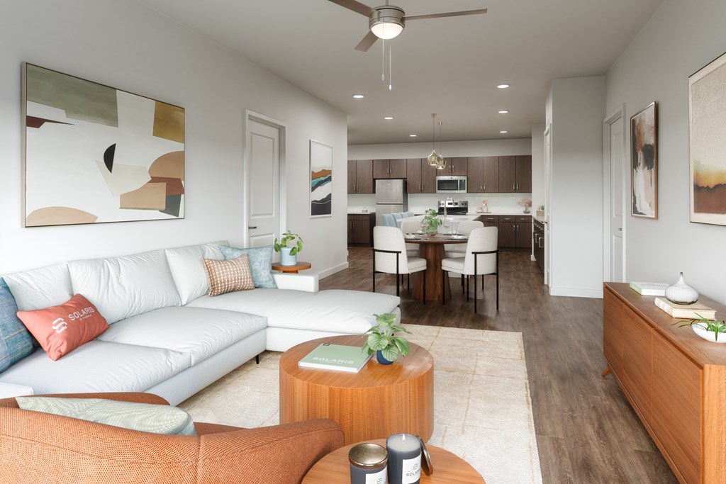 A modern living room with a white couch and a wooden coffee table.