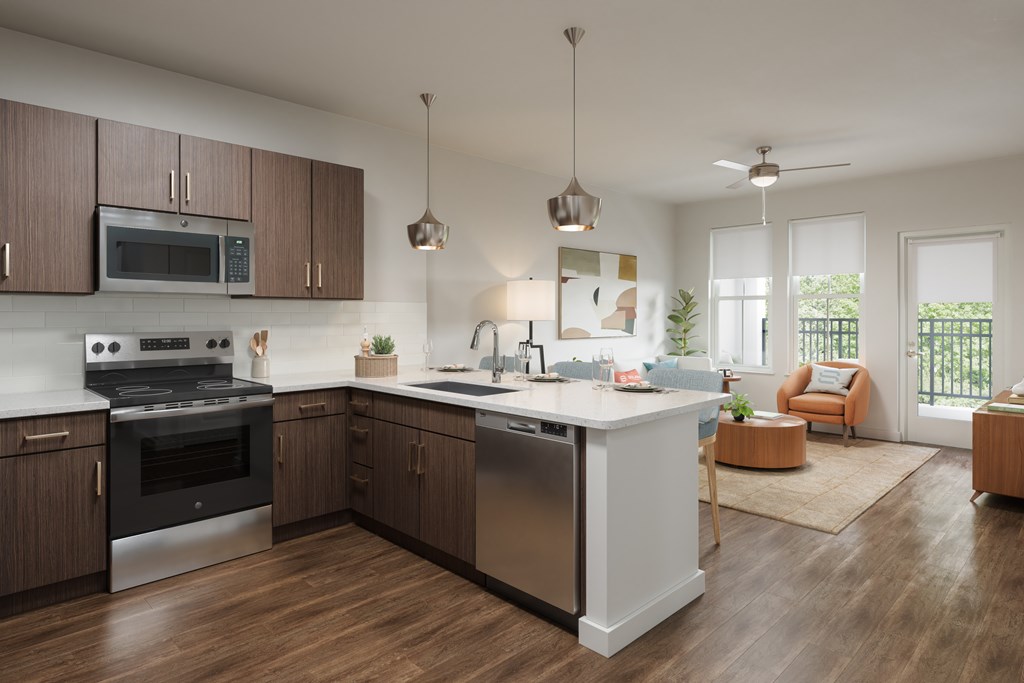 A modern kitchen with dark wood cabinets and stainless steel appliances.