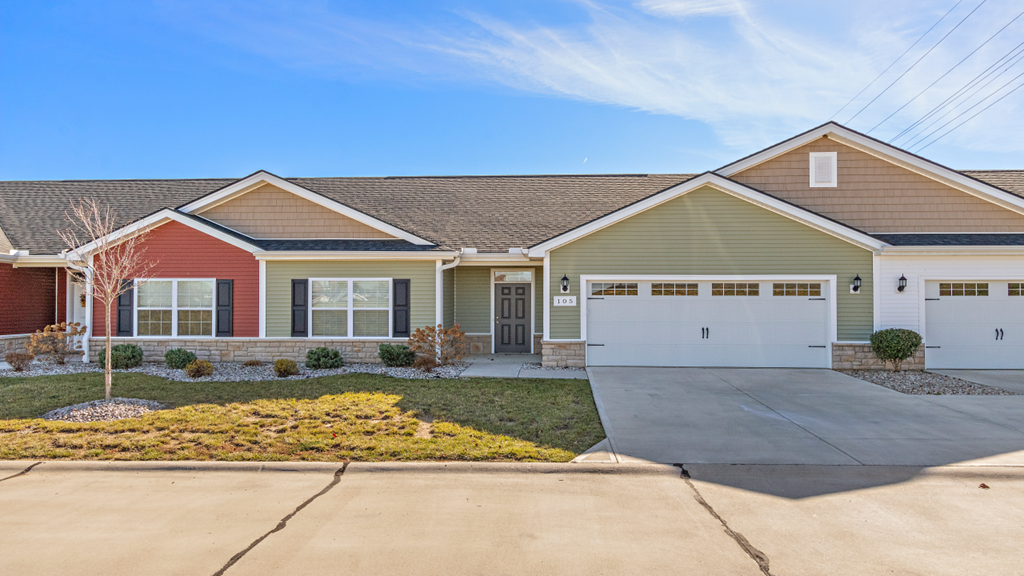a house with a white garage door and a driveway