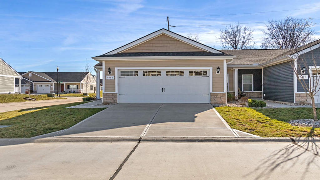 a driveway in front of a house with a white garage door