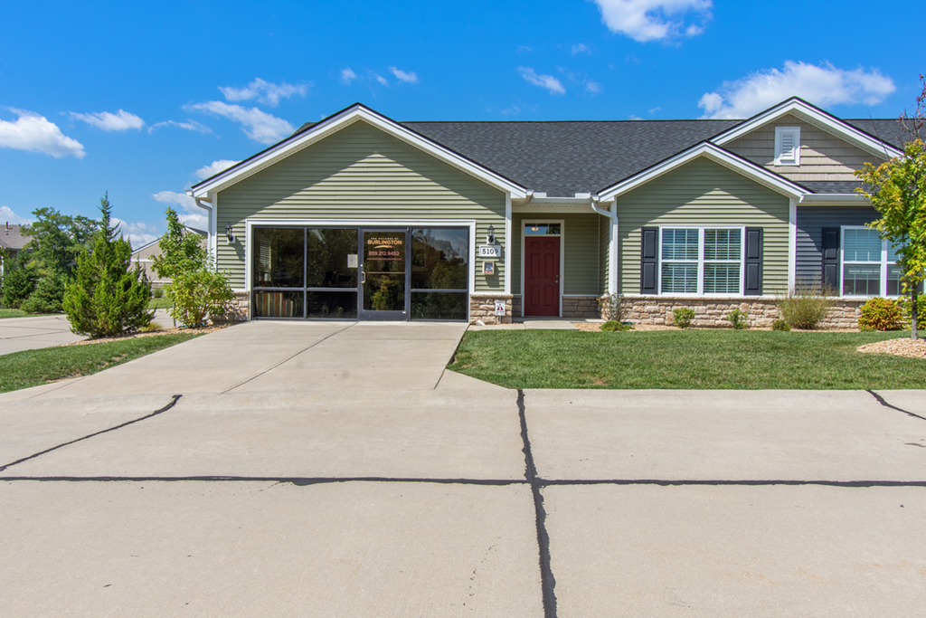 an empty driveway in front of a house