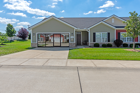 a house with a driveway and a lawn