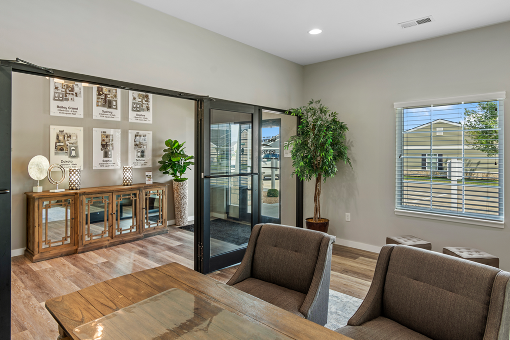 a living room with a table and chairs and a sliding glass door