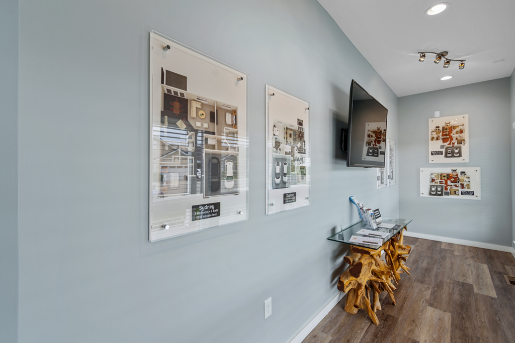 a room with three pictures on the wall and a desk