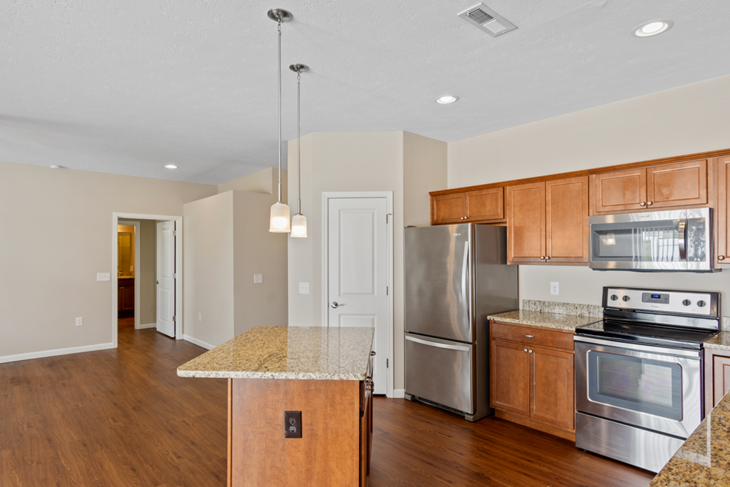 a kitchen with stainless steel appliances and granite counter tops