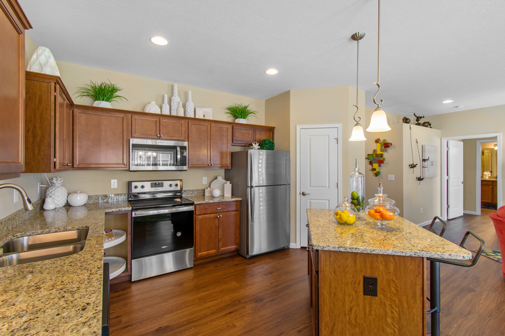 a kitchen with stainless steel appliances and granite counter tops