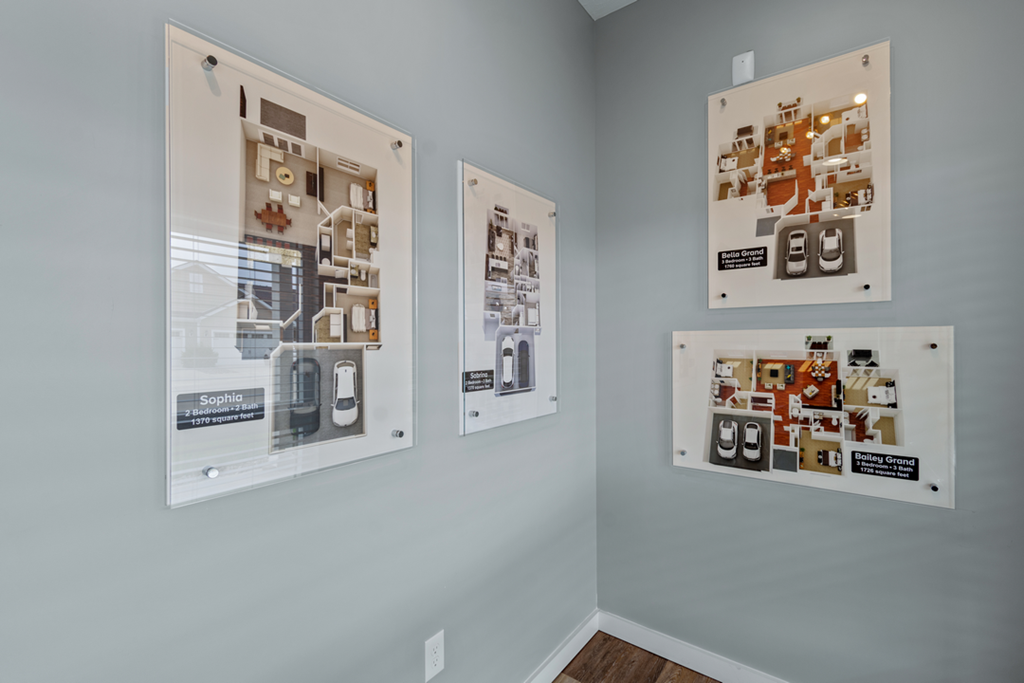 three pictures hanging on a wall in a room