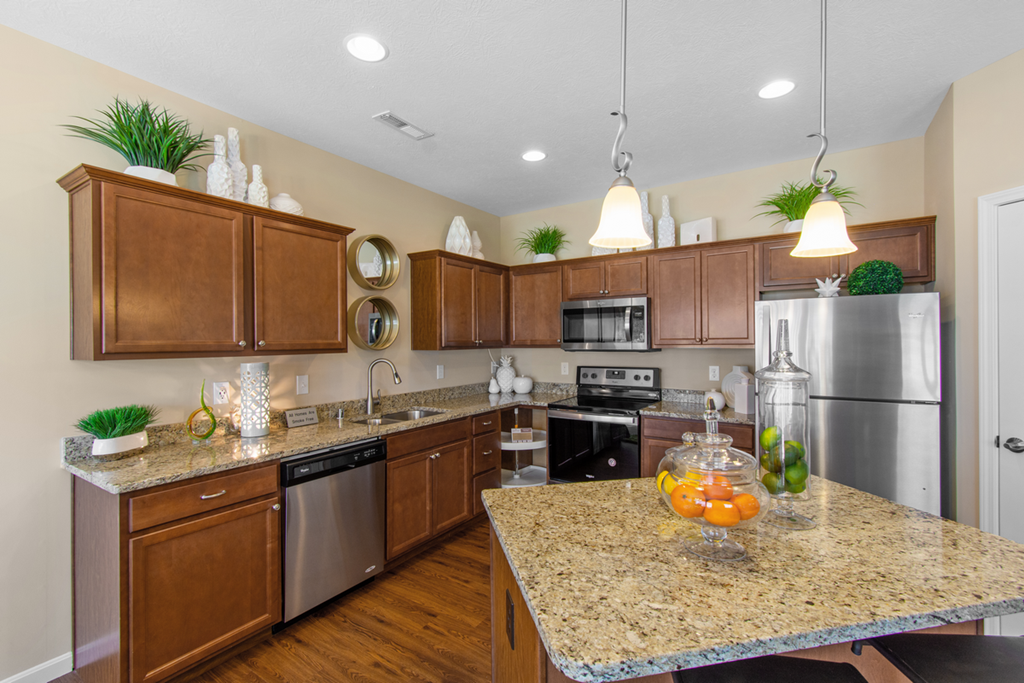 a kitchen with stainless steel appliances and granite counter tops