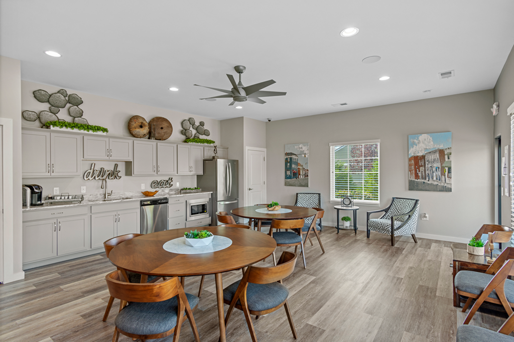 A modern kitchen with a dining table set for four.