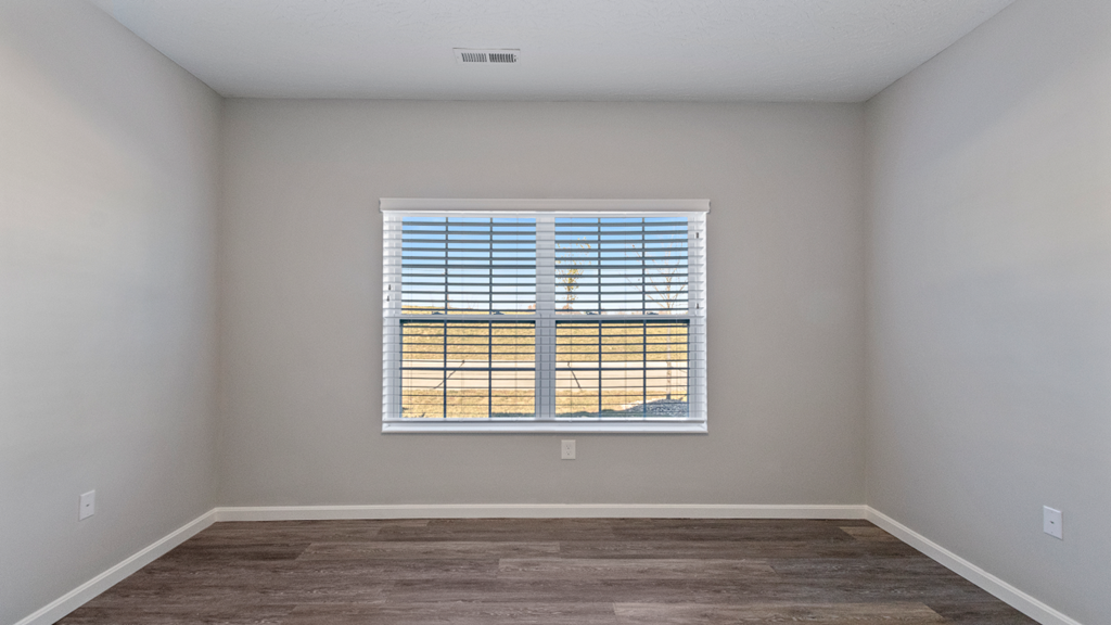 an empty room with a window overlooking a building