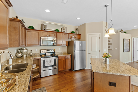a kitchen with stainless steel appliances and granite counter tops