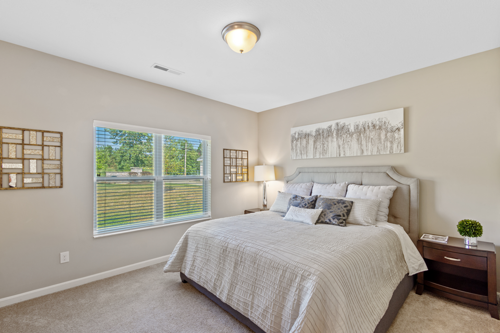 a bedroom with a large bed and a window