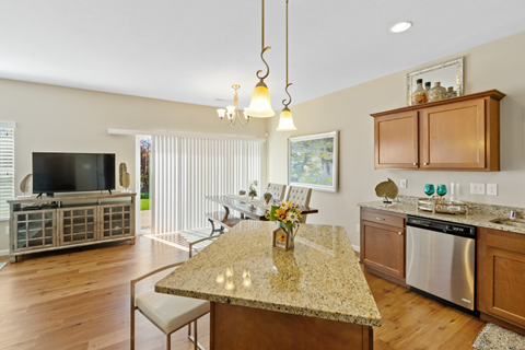 a kitchen and living room with a granite counter top