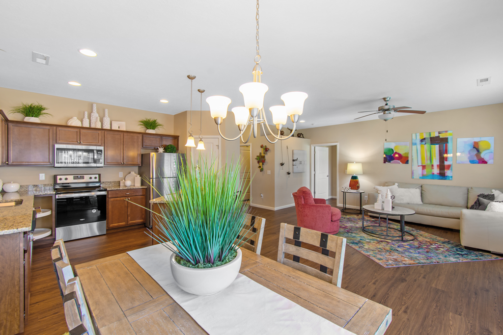 a living room with a dining room table and a kitchen