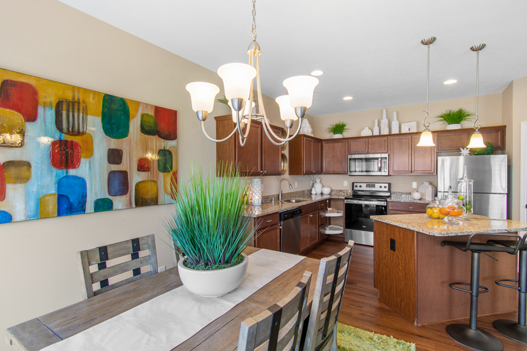 a kitchen and dining room with a table and chairs