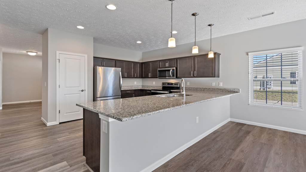 an empty kitchen with a granite counter top and