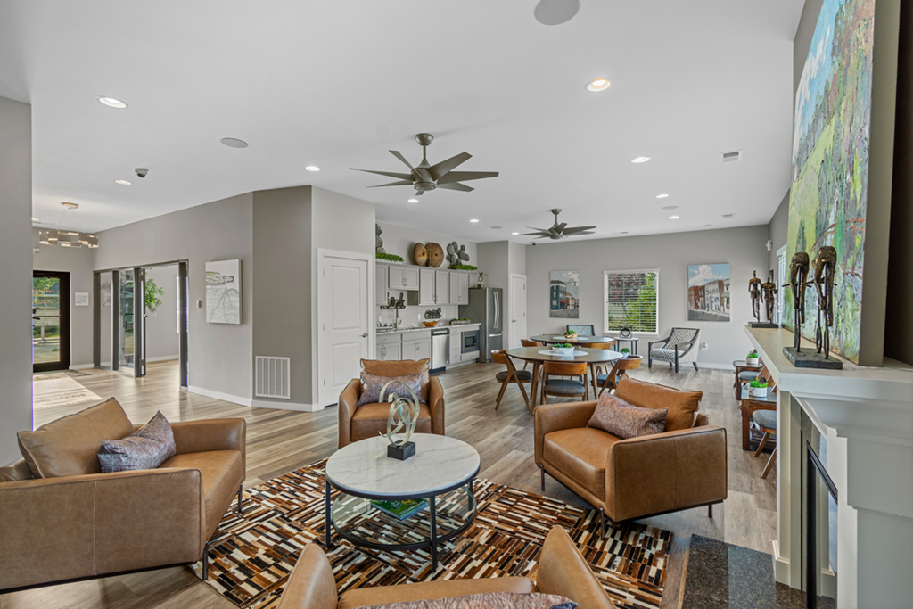 A living room with a white ceiling and a rug on the floor.