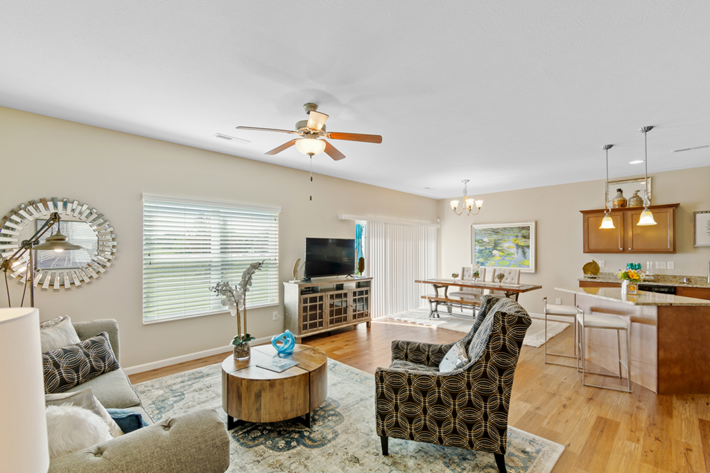a living room with furniture and a ceiling fan