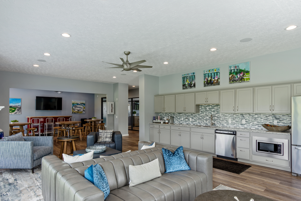 a living room and kitchen with couches and chairs