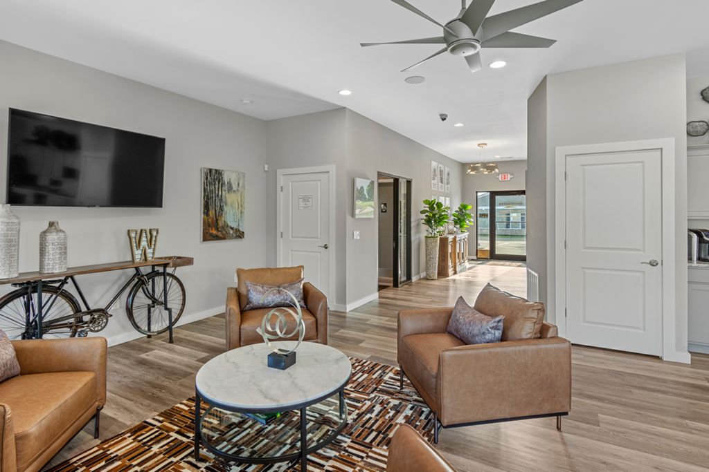 A living room with a bicycle and a flat screen TV.