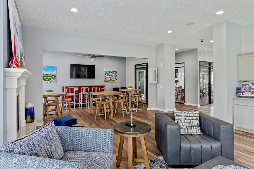 a living room with couches and chairs and a dining room with tables