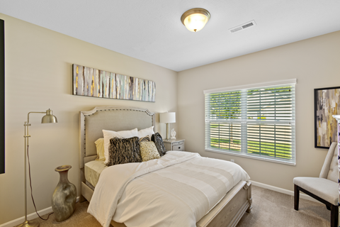 a bedroom with a large bed and a window