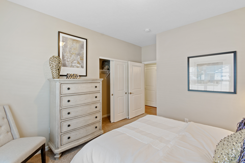 a bedroom with a bed and a dresser