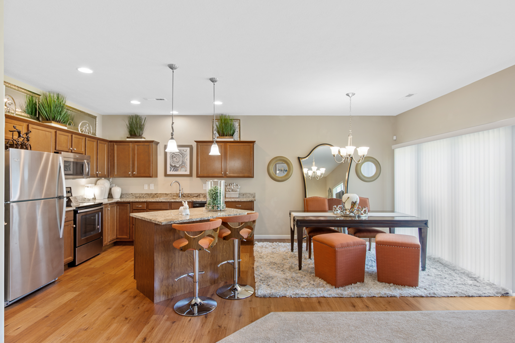 a kitchen and dining room with a table and chairs