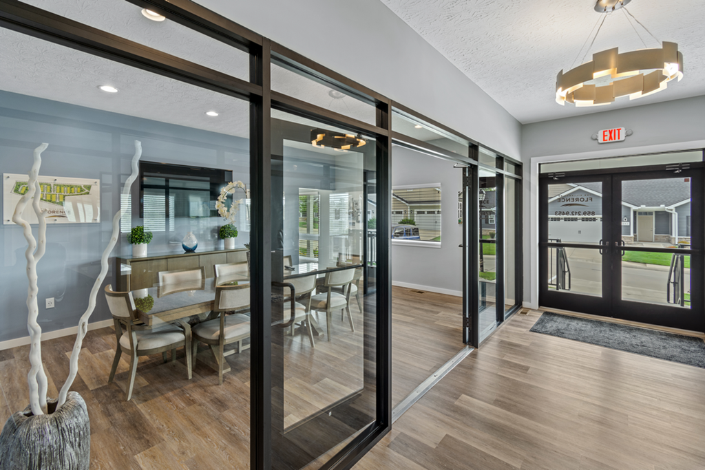 a dining room with glass sliding doors and a table and chairs