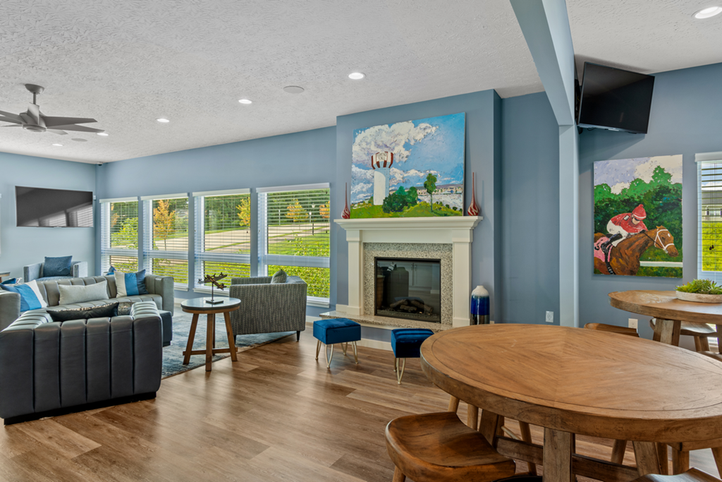 a living room with a fireplace and a table and chairs