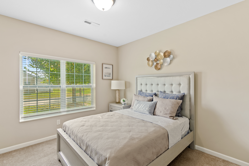 a bedroom with a bed and a window