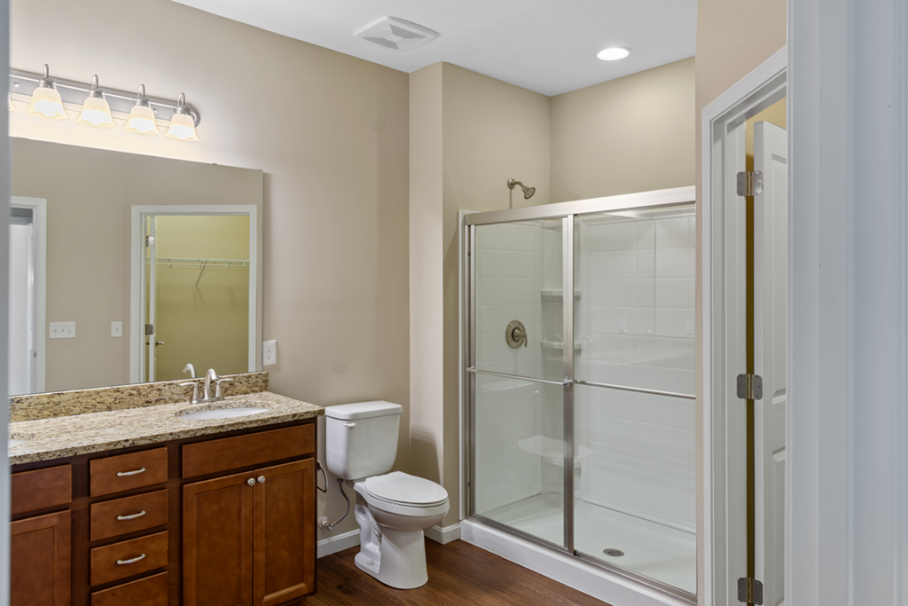 a bathroom with a shower and a sink and a toilet