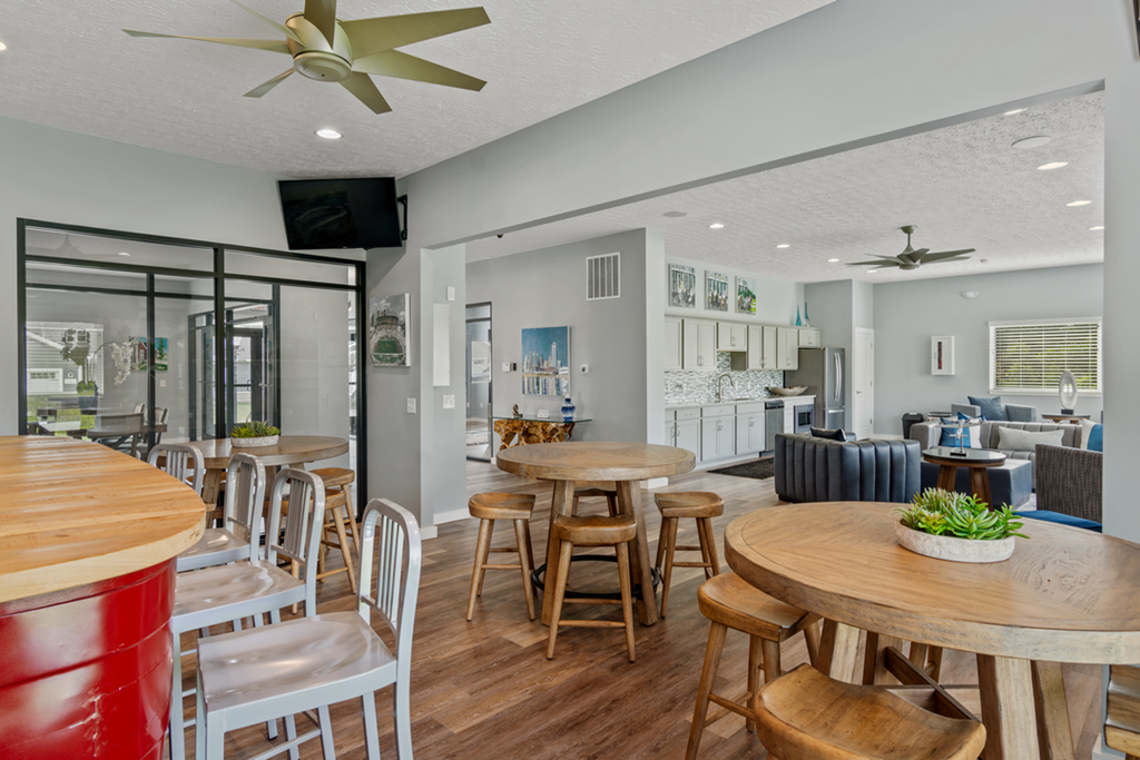 the dining room and living room of a house with tables and chairs