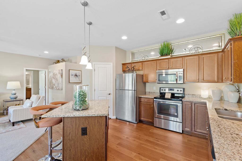 a kitchen with stainless steel appliances and granite counter tops