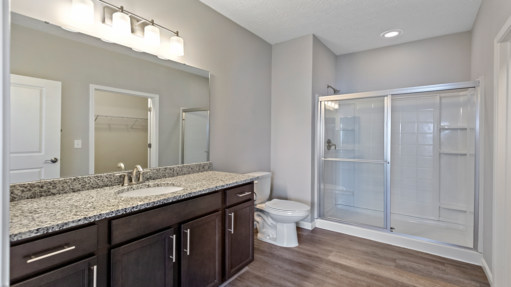 an empty bathroom with a shower toilet and sink