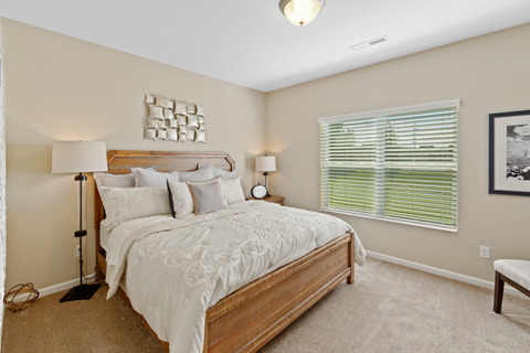 a bedroom with a large bed and a window