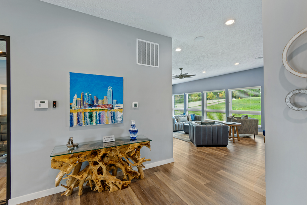 a living room with a table and a painting on the wall