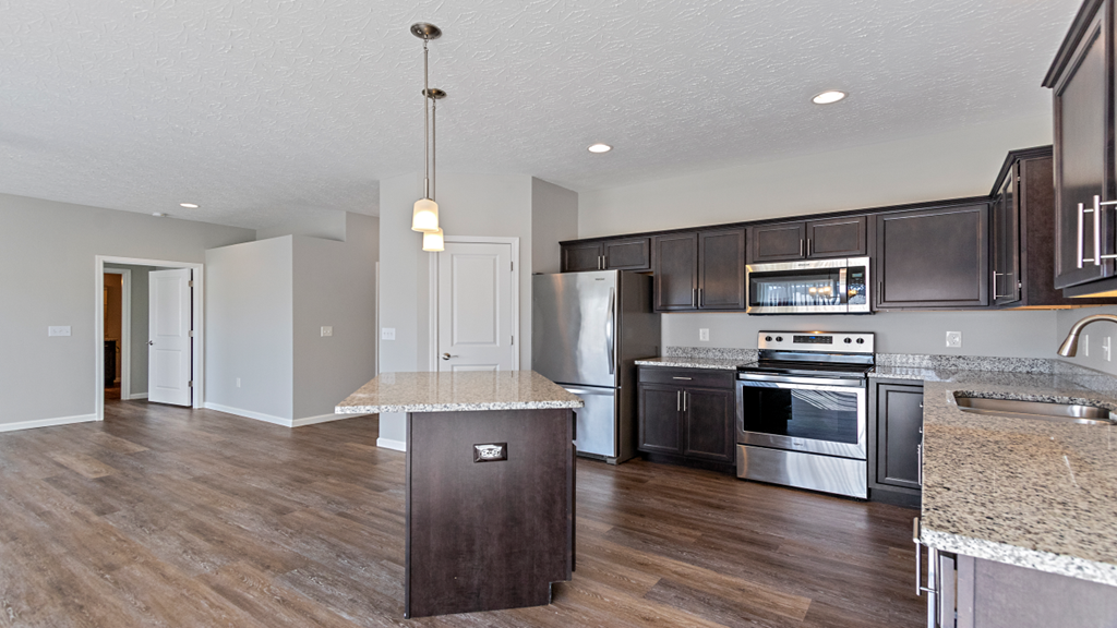 a kitchen with stainless steel appliances and granite counter tops