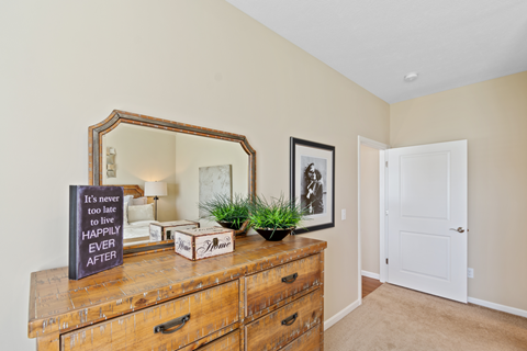 a living room with a dresser and a mirror