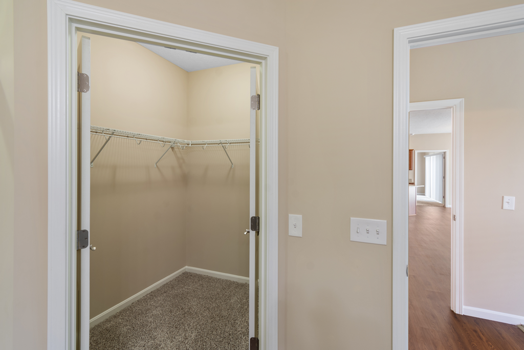 an empty closet in a room with a door open