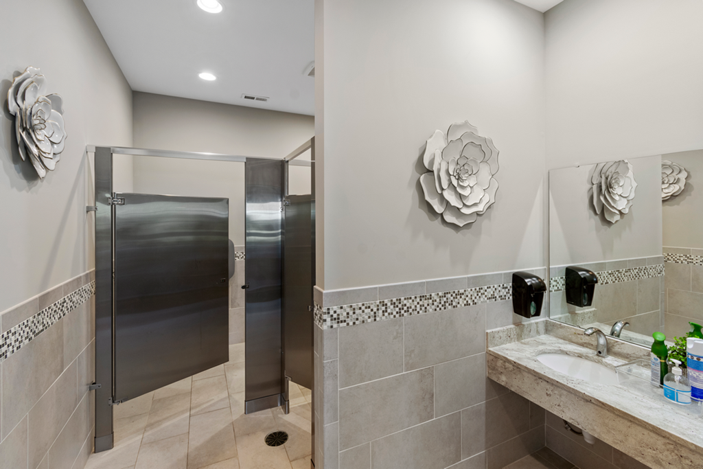 a bathroom with a shower and a sink and a mirror