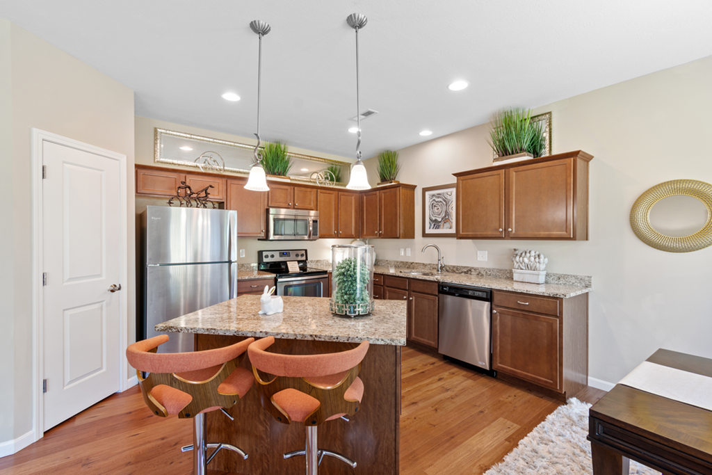 a kitchen with stainless steel appliances and a granite counter top