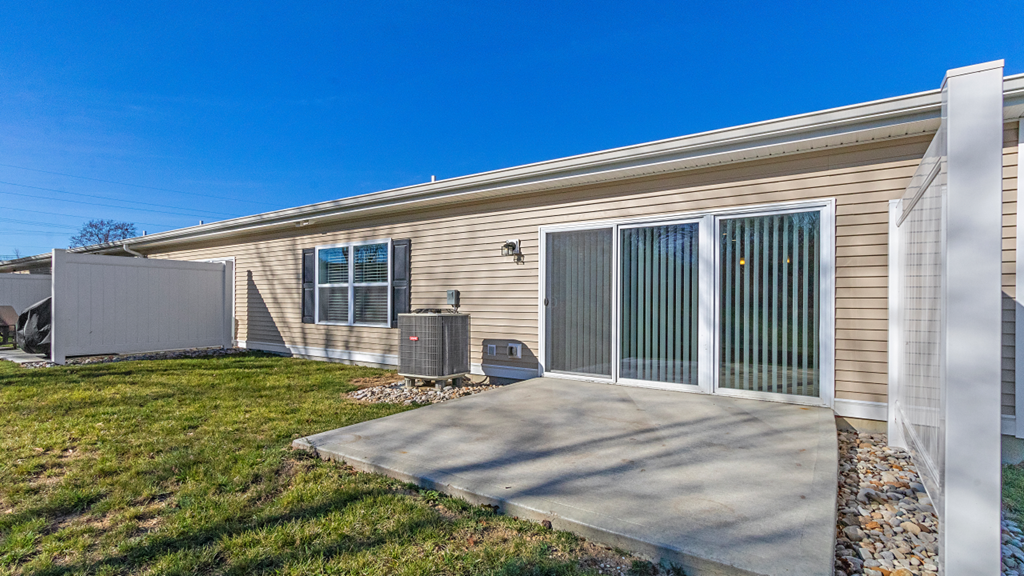 the exterior of a home with a patio and a yard