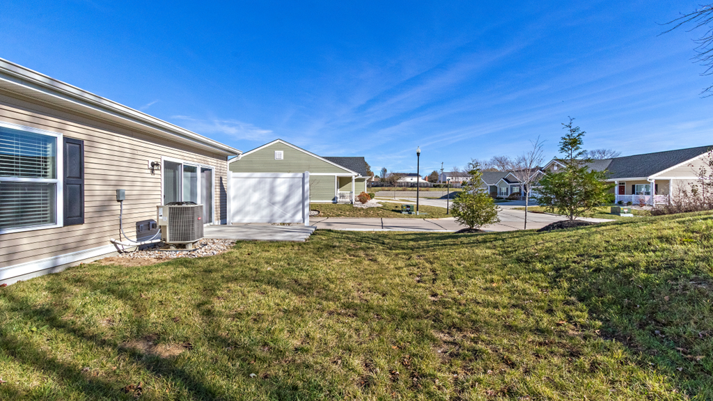 the back yard of a house with a yard and grass