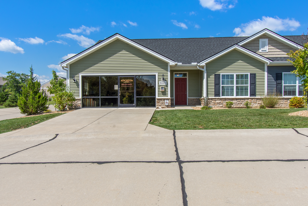 an empty driveway in front of a house