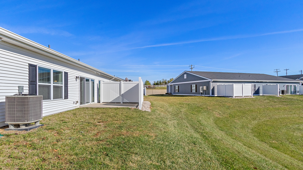 a home with a yard and a house in the background