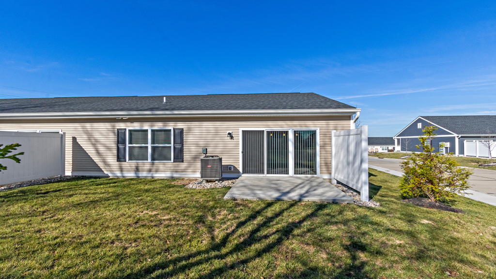the front of a house with a yard and a garage door